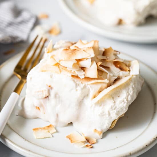 a white plate topped with a piece of cake.