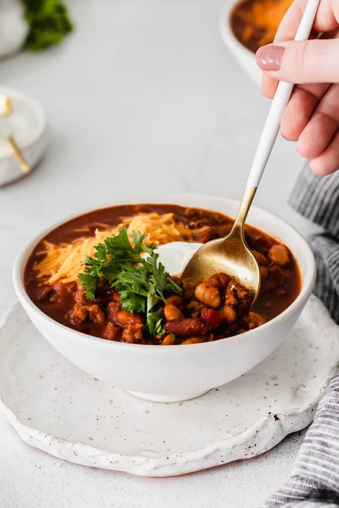 instant pot chili in a bowl with a spoon.