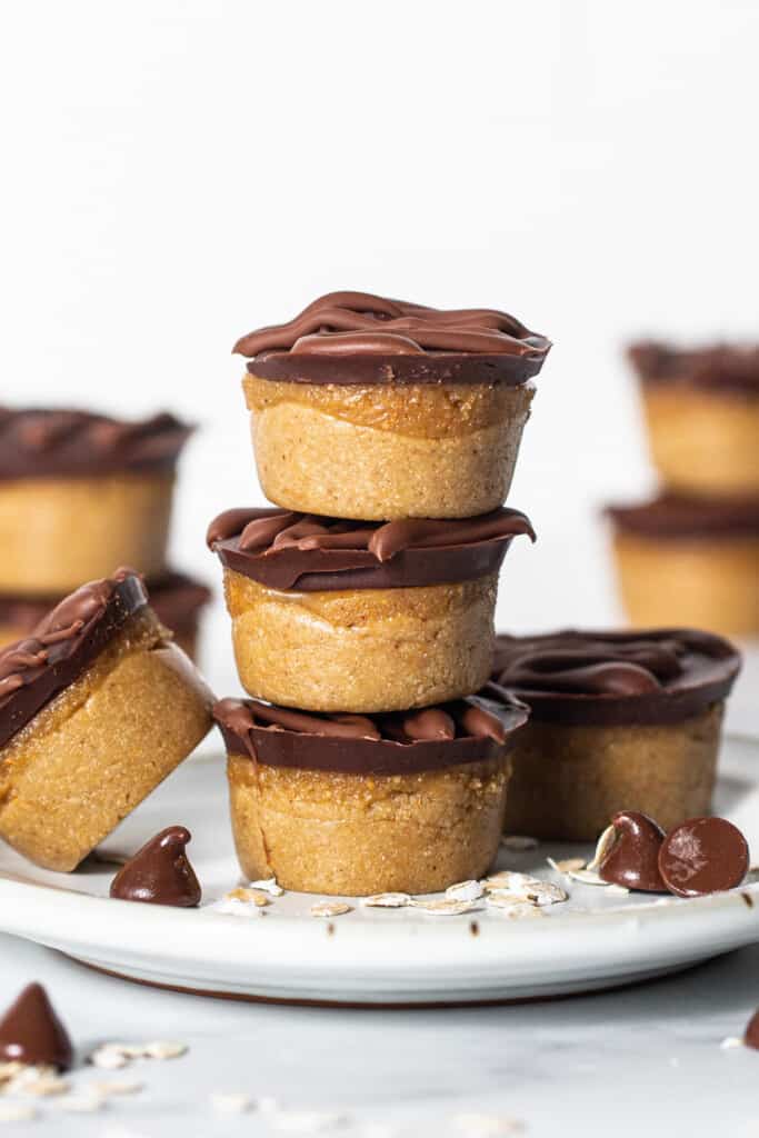 A stack of chocolate peanut butter cups on a plate.