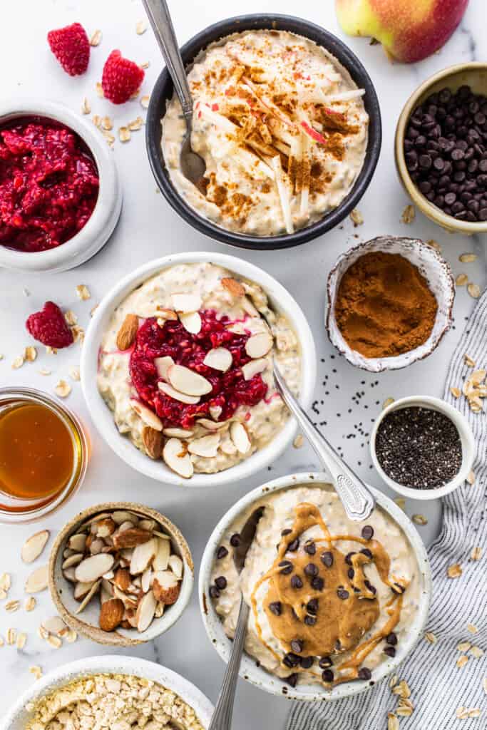 a table topped with bowls of oatmeal and fruit.