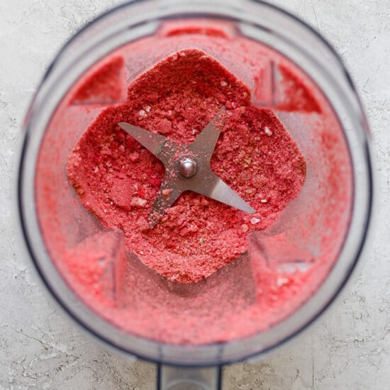 A food processor filled with a pink substance.