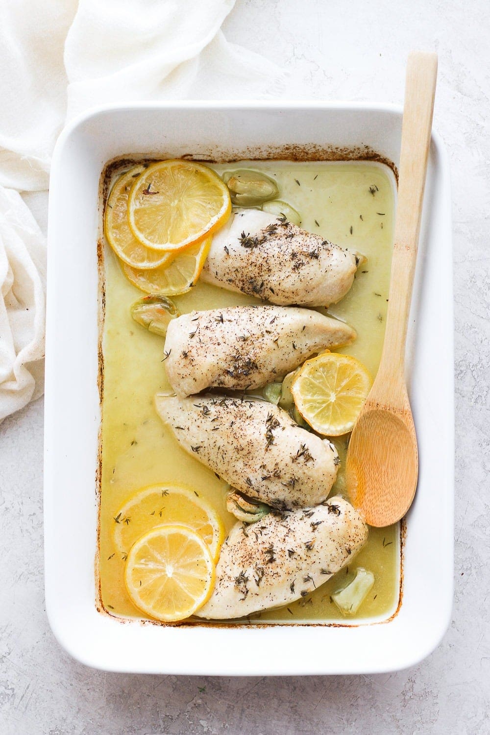 Baked lemon chicken in casserole dish.