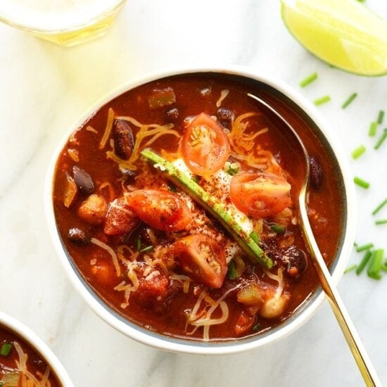 A vegetarian bowl of chili packed with beans, tomatoes, and cheese.