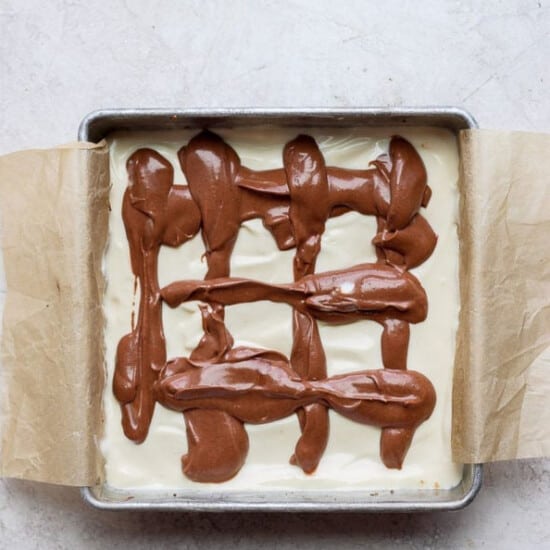 A brownie with chocolate icing in a baking pan.