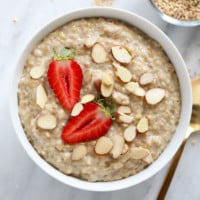 A healthy breakfast idea consisting of oatmeal topped with strawberries and almonds.