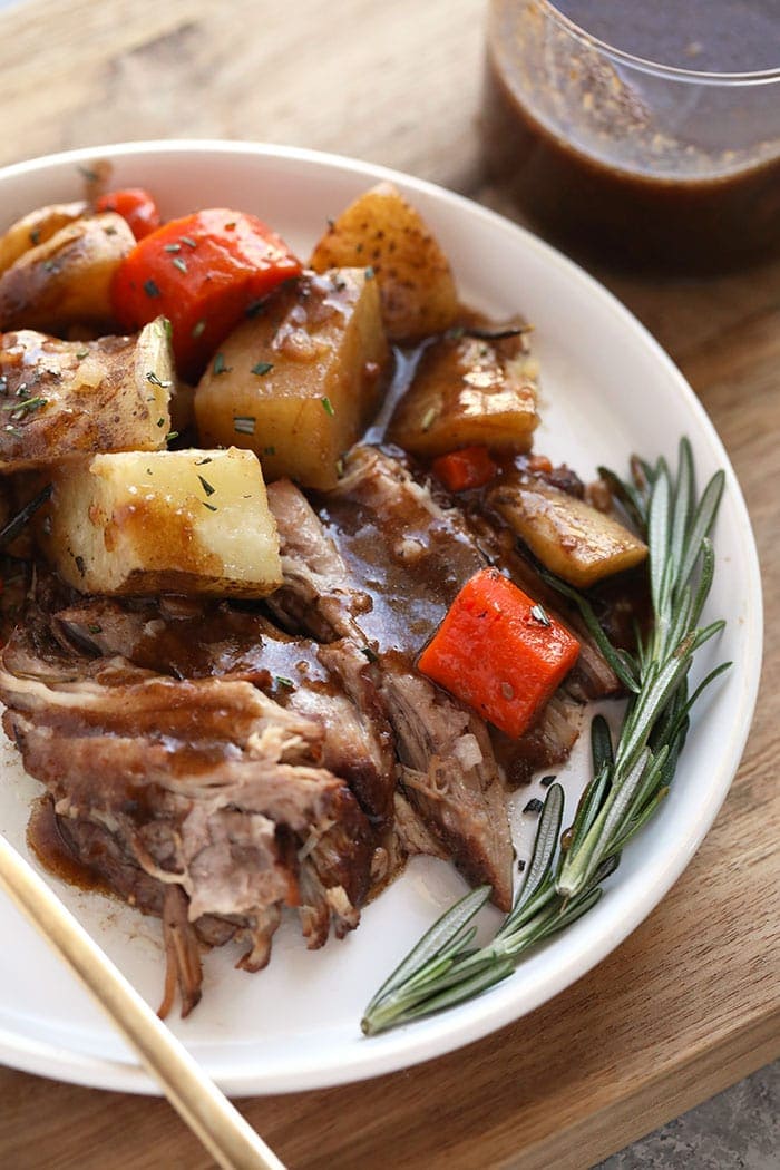 Pork roast and vegetables with balsamic wine glaze on a plate