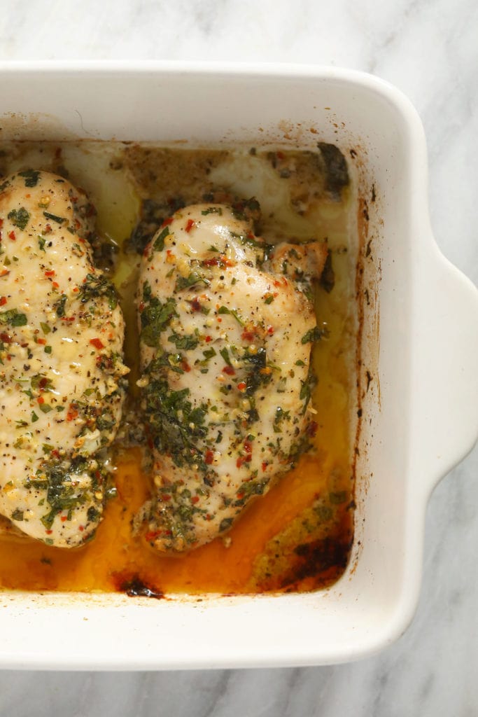 Italian chicken baking in baking dish.