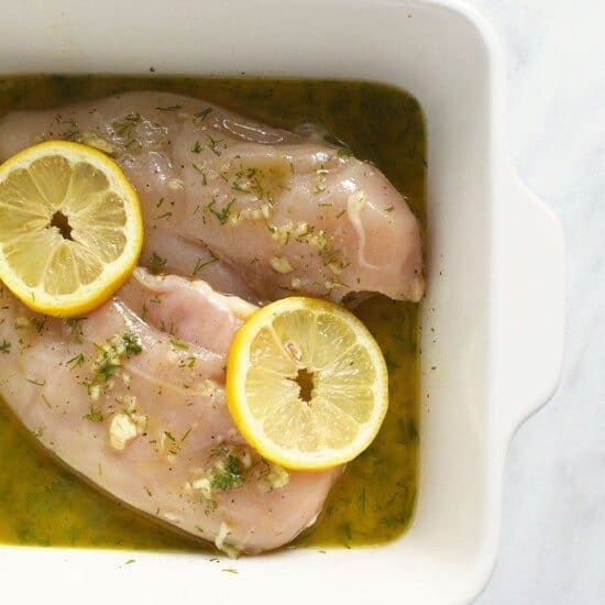 marinated chicken breast in dish.