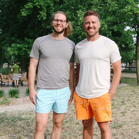 a couple of men standing next to each other.