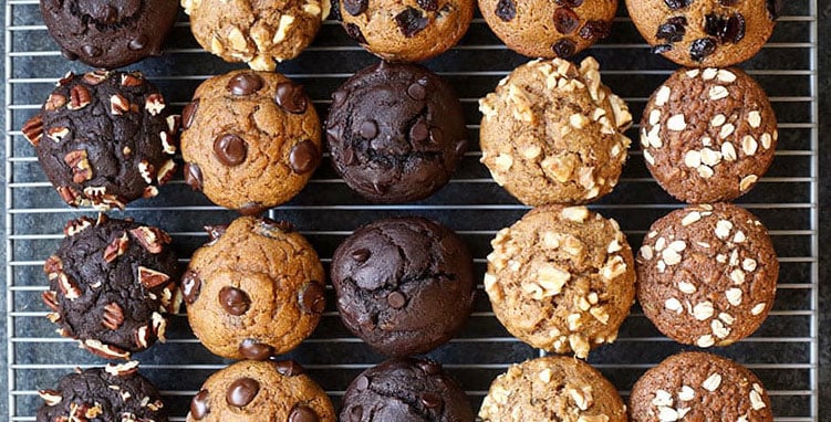 6 different muffins on wire rack.