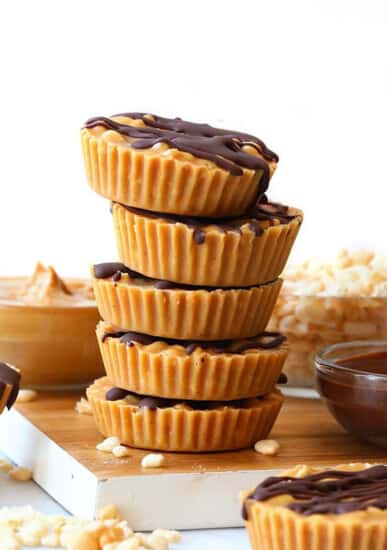 A stack of peanut butter cups on a cutting board.