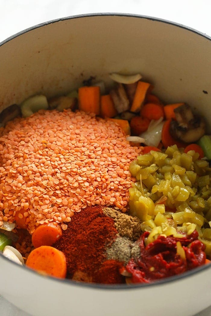 All the ingredients for lentil stew in a pot. 